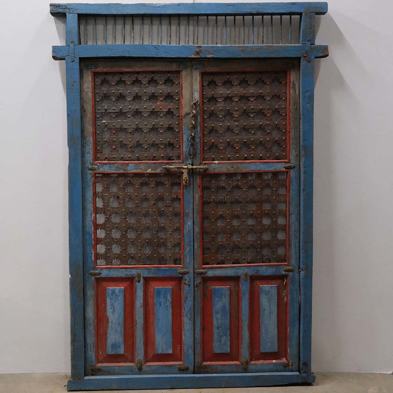 Large old wooden gate with iron grids